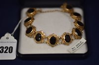 Lot 320 - 9ct Gold and Garnet bracelet