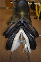 Lot 200 - Three saddles and a stand