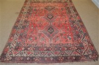 Lot 673 - A South West Persian rug, the red field with...