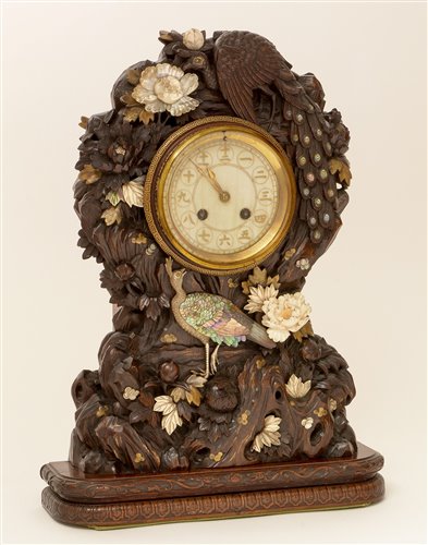 Lot 676 - A rare and unusual Japanese carved mantel clock.