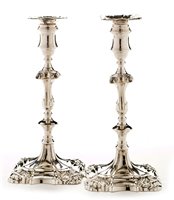 Lot 422 - A pair of George III candlesticks.