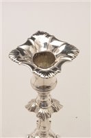 Lot 422 - A pair of George III candlesticks.