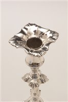 Lot 422 - A pair of George III candlesticks.