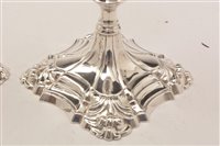 Lot 422 - A pair of George III candlesticks.