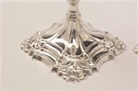 Lot 422 - A pair of George III candlesticks.