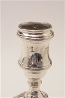 Lot 422 - A pair of George III candlesticks.