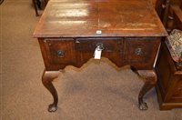 Lot 1189 - A Georgian style figured walnut and banded lowboy.