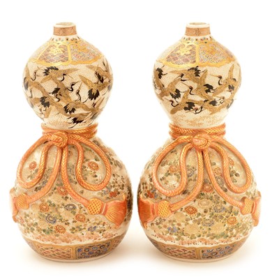 Lot 51 - A pair of 19th Century Japanese earthenware double gourd shaped wine bottles.