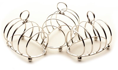 Lot 487 - Three silver toast racks