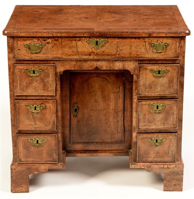 Lot 841 - A walnut kneehole desk.