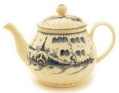 Lot 115 - An underglaze blue decorated Creamware teapot.