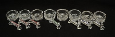Lot 196 - A set of seven pressed and cut glass knife rests; and a set of eight table salts.