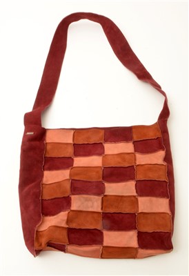 Lot 1489 - Chanel: A suede hand bag, in claret, brown and...