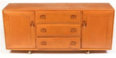Lot 1597 - Ercol: a light elm Windsor style sideboard.