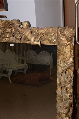 Lot 1034 - A Baroque style giltwood wall mirror