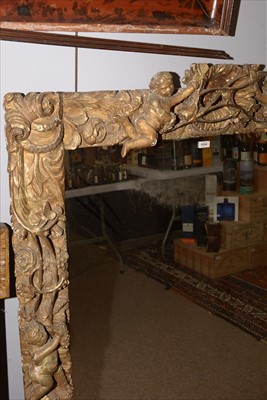 Lot 1034 - A Baroque style giltwood wall mirror