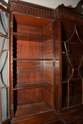 Lot 1226 - A George III mahogany breakfront secretaire bookcase.