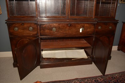 Lot 1226 - A George III mahogany breakfront secretaire bookcase.