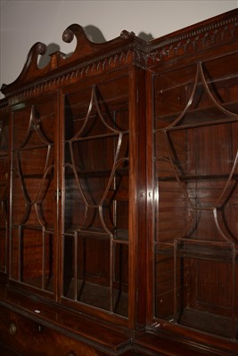 Lot 1226 - A George III mahogany breakfront secretaire bookcase.