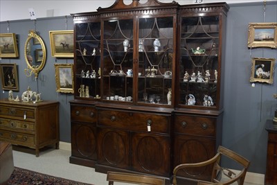 Lot 1226 - A George III mahogany breakfront secretaire bookcase.