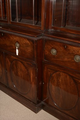 Lot 1226 - A George III mahogany breakfront secretaire bookcase.