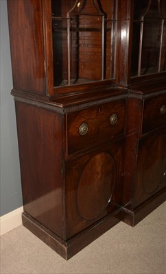 Lot 1226 - A George III mahogany breakfront secretaire bookcase.