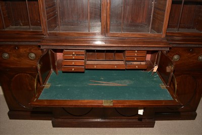 Lot 1226 - A George III mahogany breakfront secretaire bookcase.
