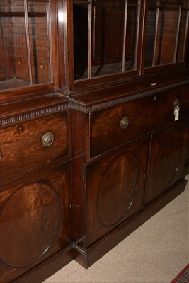 Lot 1226 - A George III mahogany breakfront secretaire bookcase.