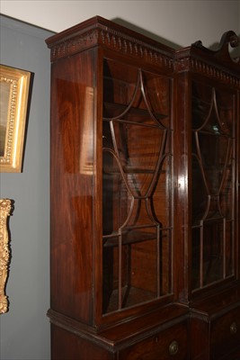 Lot 1226 - A George III mahogany breakfront secretaire bookcase.