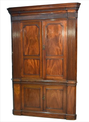 Lot 1014 - A large George III mahogany corner cabinet