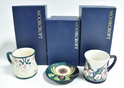 Lot 519 - Moorcroft - Two mugs and a dish