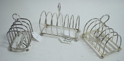 Lot 224 - Three silver toast racks