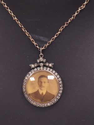 Lot 44 - A paste set locket on chain