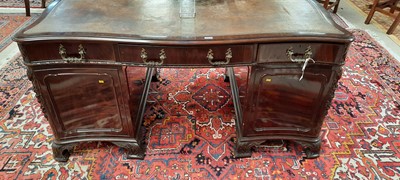 Lot 742 - George III style mahogany serpentine pedestal desk