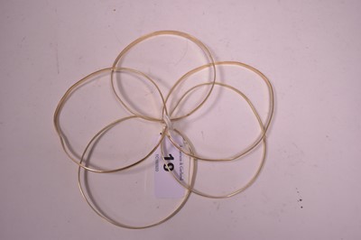 Lot 19 - Five yellow metal bangles