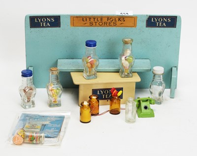 Lot 939 - A mid 20th Century British painted wood "Little Folks" doll's shop, and accessories.