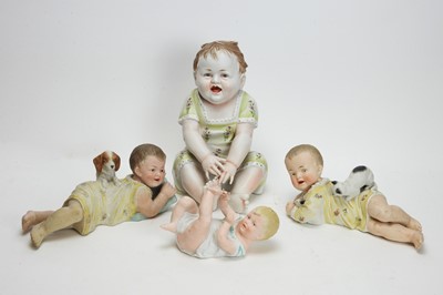 Lot 1015 - A pair of bisque piano baby dolls, and two others.