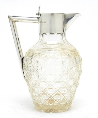 Lot 137 - A late Victorian cut glass and silver-mounted claret jug.
