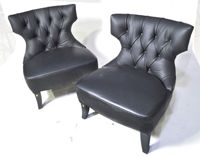 Lot 48 - A pair of designer faux black leather easy chairs.