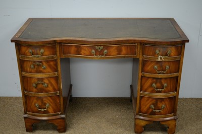 Lot 4 - A Georgian style mahogany serpentine front pedestal desk.