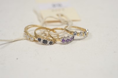 Lot 54 - Four gem-set rings.