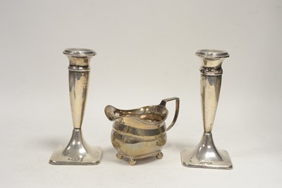 Lot 73 - A pair of silver candlesticks; and a cream jug.