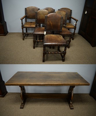 Lot 130 - Six Carolean style oak dining chairs; and a plank top refectory style dining table.