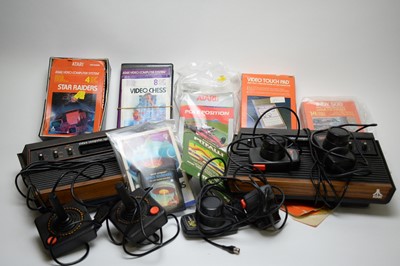 Lot 781 - Two vintage Atari video computer game consoles and accessories.