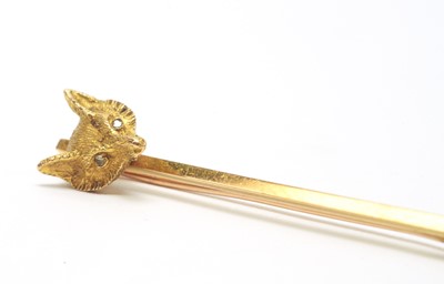 Lot 52 - An early 20th C yellow metal fox head pattern tie pin.