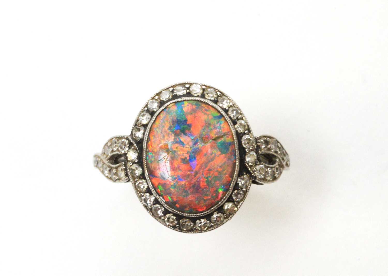 Lot 54 - A black opal and diamond cluster ring.