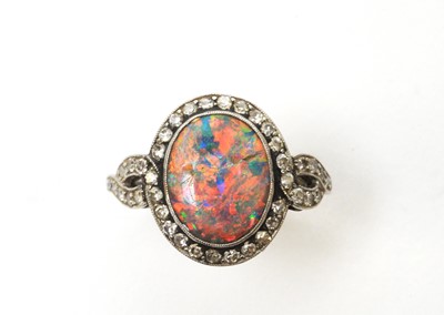 Lot 54 - A black opal and diamond cluster ring.