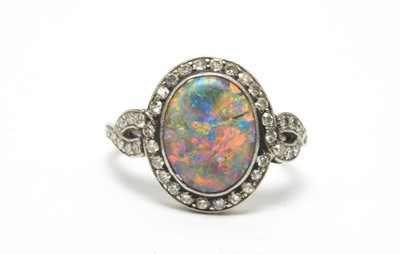 Lot 54 - A black opal and diamond cluster ring.