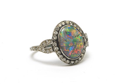 Lot 54 - A black opal and diamond cluster ring.