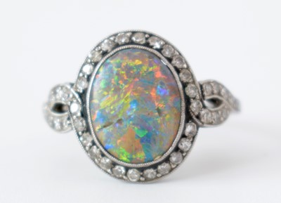 Lot 54 - A black opal and diamond cluster ring.